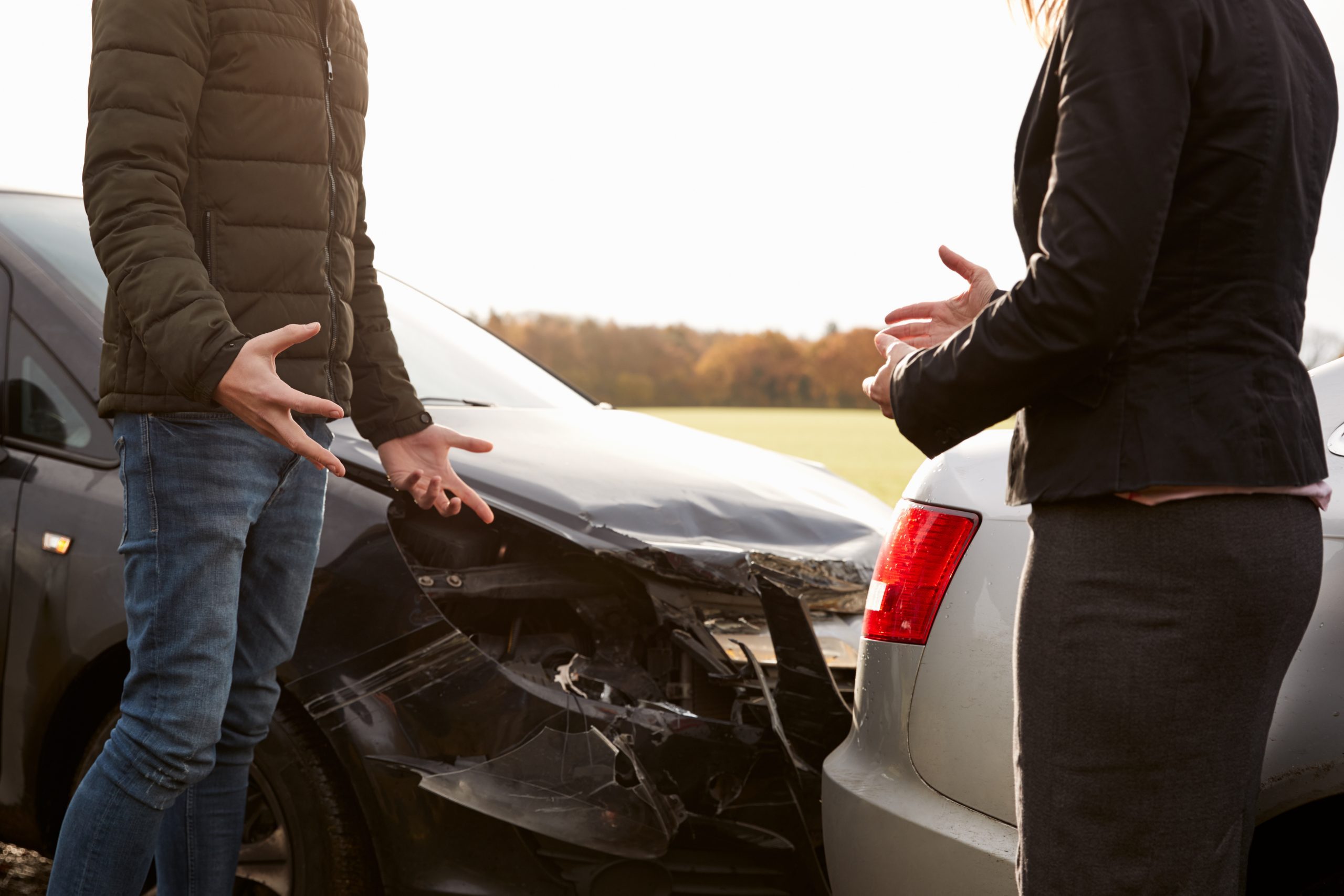 Photo of Two People Arguing After a Rear-End Collision