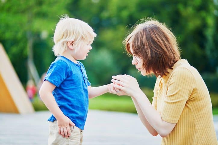 Mother comforting son after he injured his hand