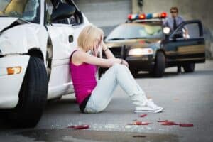 A police officer at a car accident scene.