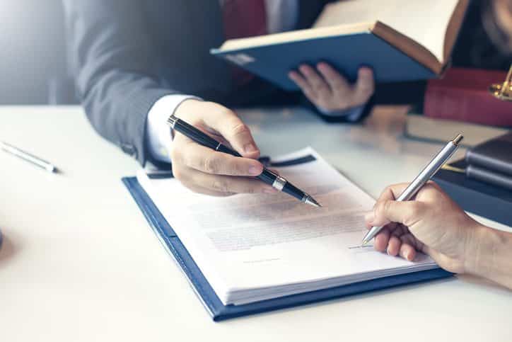 Lawyer pointing to the form signing of the contract agreement.