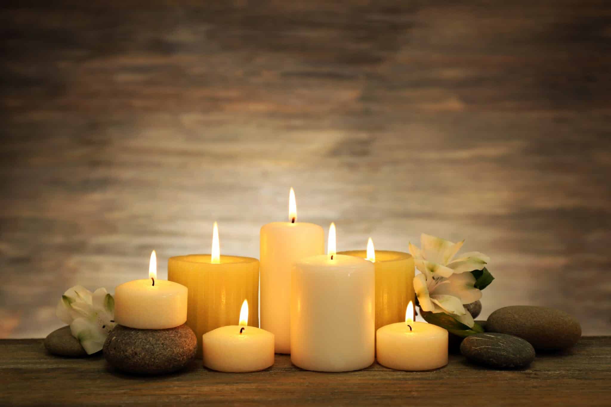 beautiful-composition-with-candles-and-spa-stones-on-wooden-background-scaled-1-2048x1366